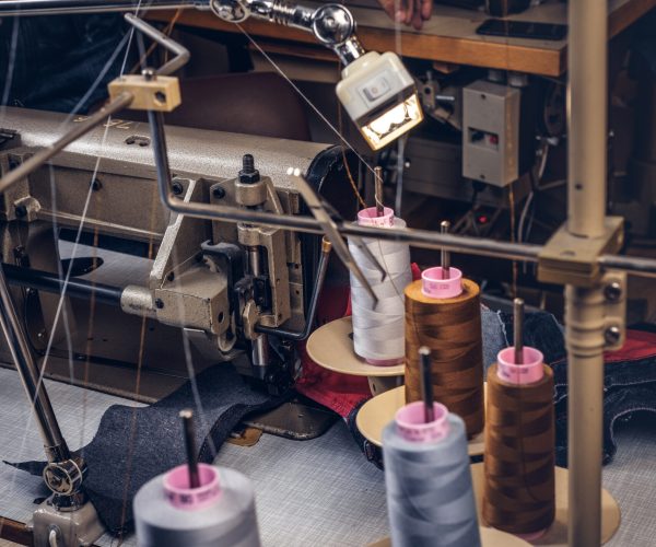 Picture of a tailor's desktop at a sewing workshop.